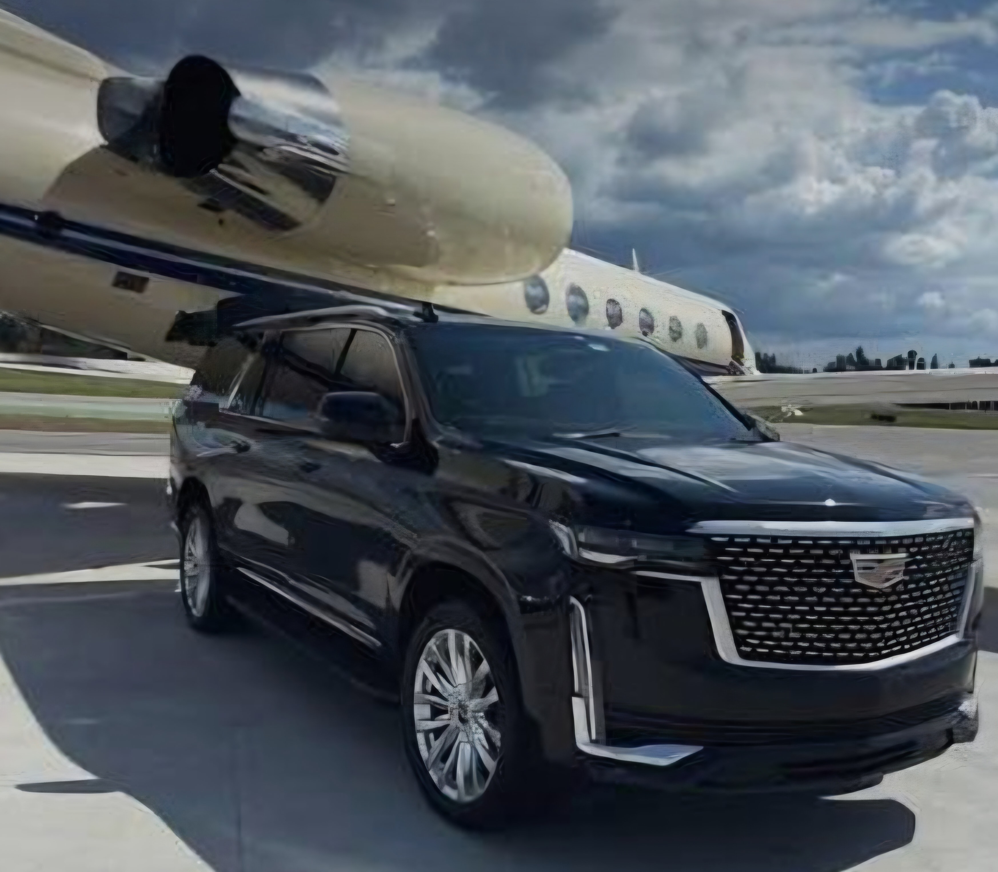 Cadillac Escalade at airport tarmac with private jet