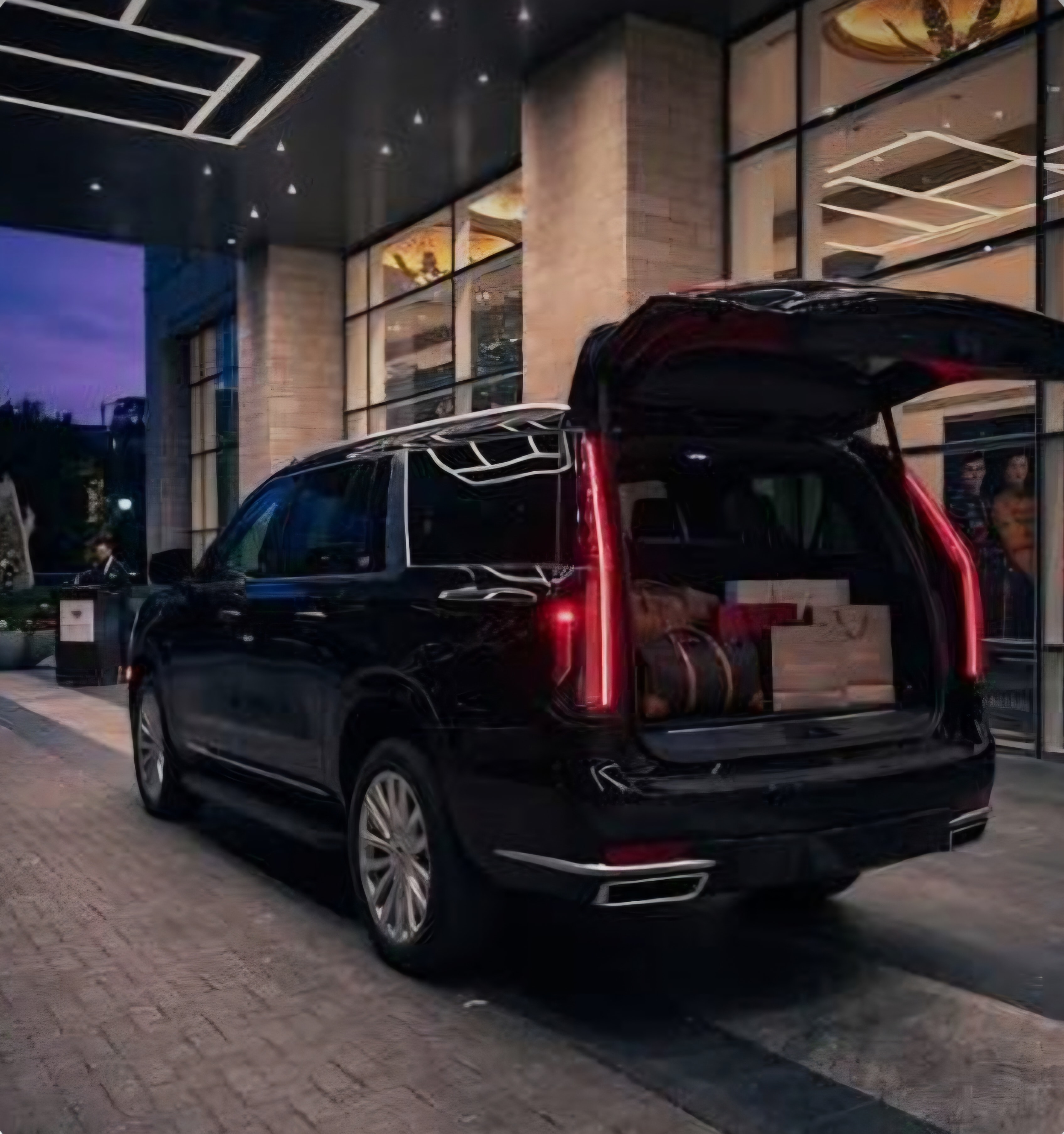 Cadillac Escalade ESV rear cargo open at hotel