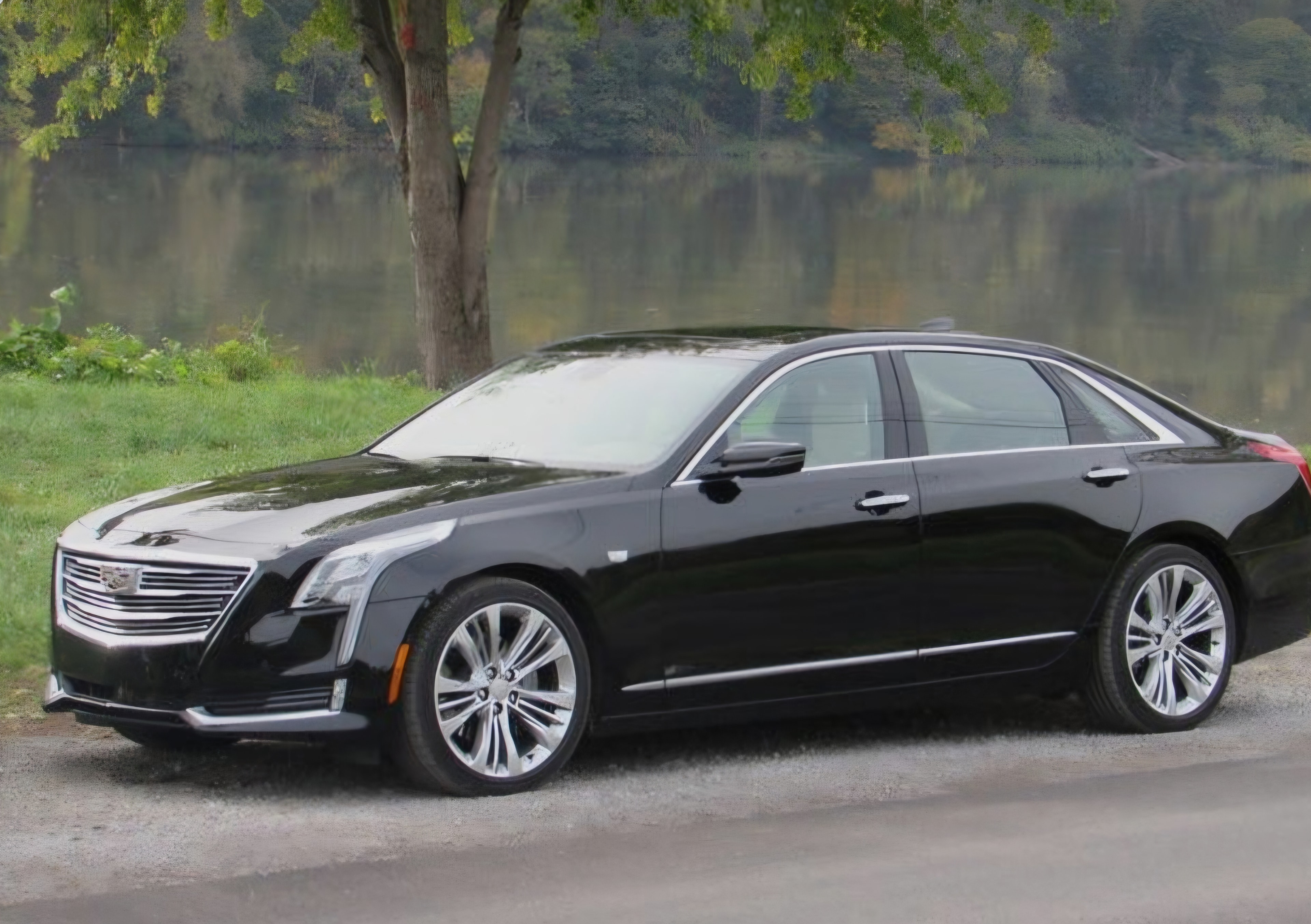 Black Cadillac CT6 luxury sedan by the lake